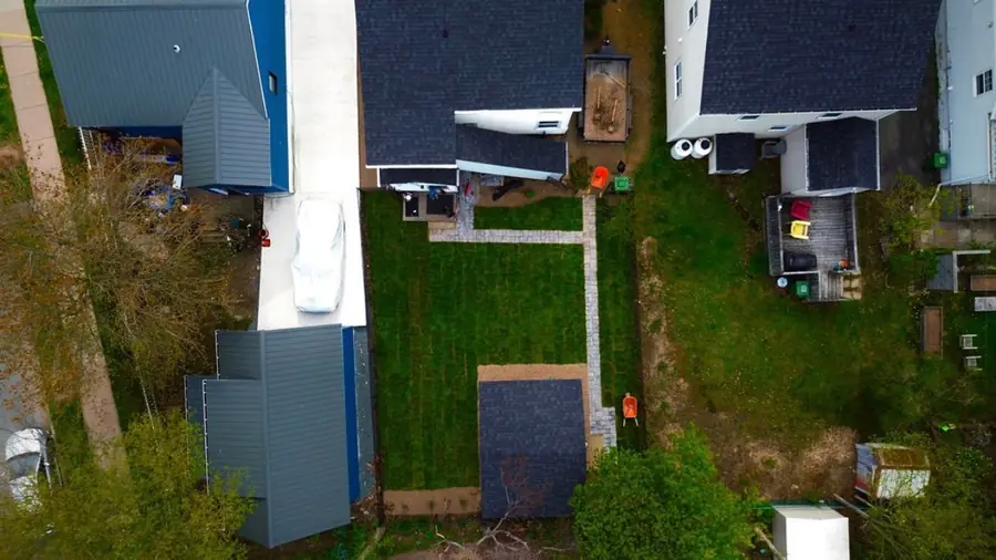 Drone view of a backyard with a freshly cut lawn and stone walkway — aerial drone view in the Halifax Regional Municipality, Nova Scotia