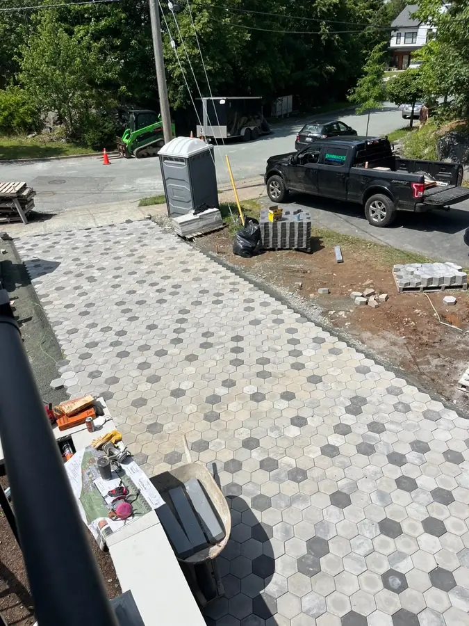 Hexagon paver walkway being installed beside a driveway, seen from above — hardscaping project in Halifax, Nova Scotia