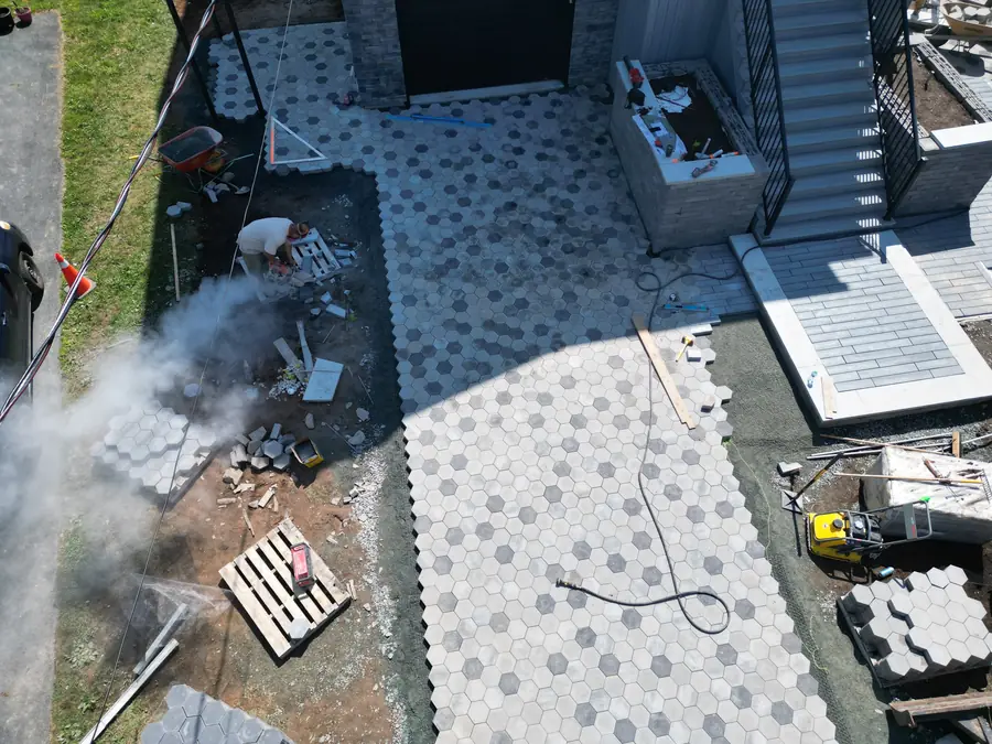 Aerial view of a hexagon paver driveway under construction beside a new home — hardscaping project in Halifax, Nova Scotia
